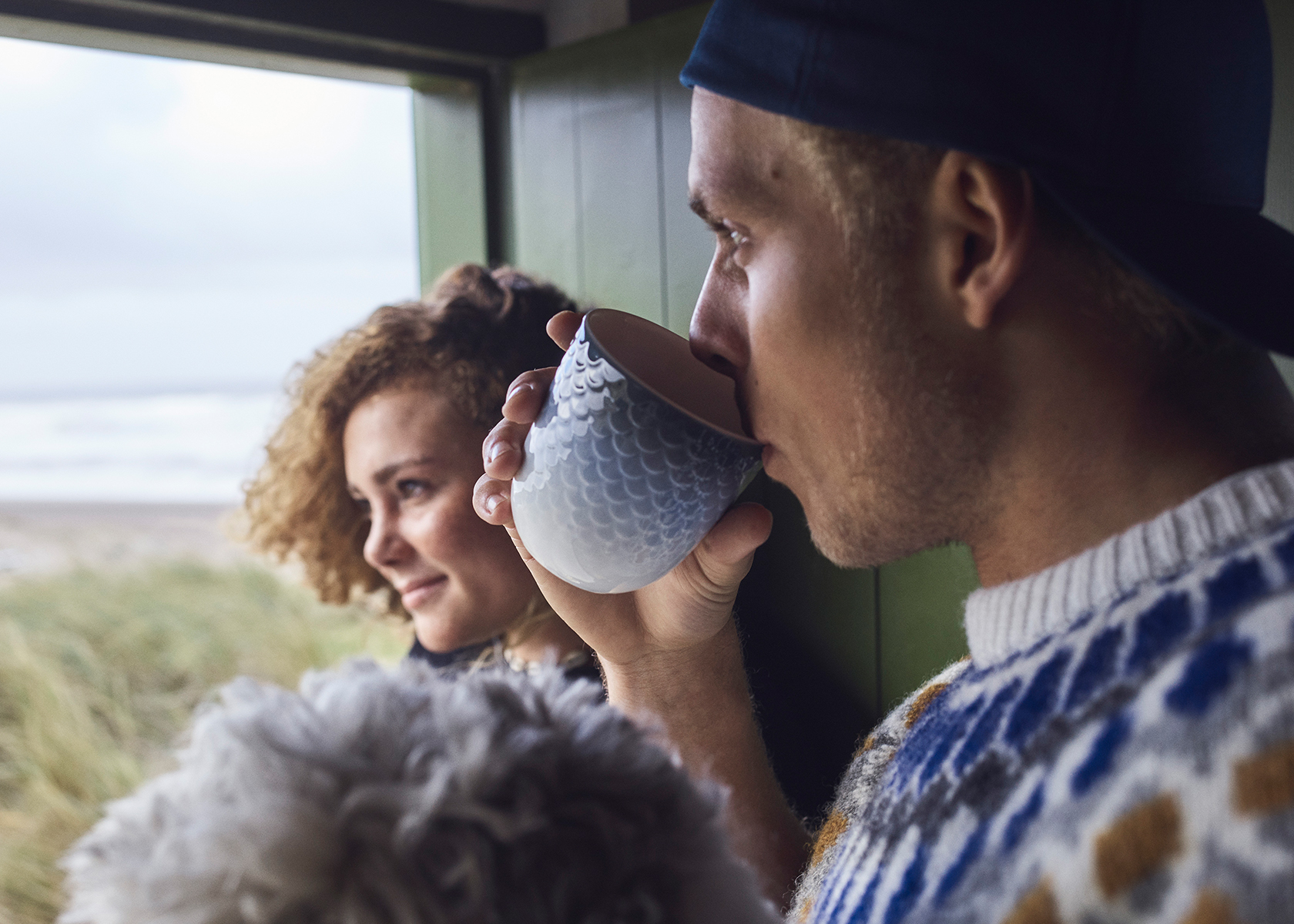 Surfer drinking his morning coffee from a HAV Thermal Mug